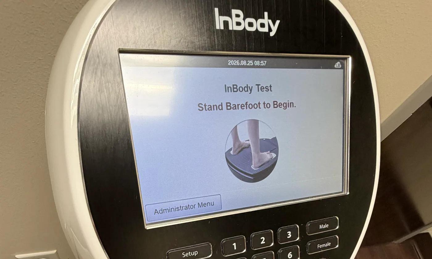 The InBody analyser's console, its screen reading: InBody Test, stand barefoot to begin.